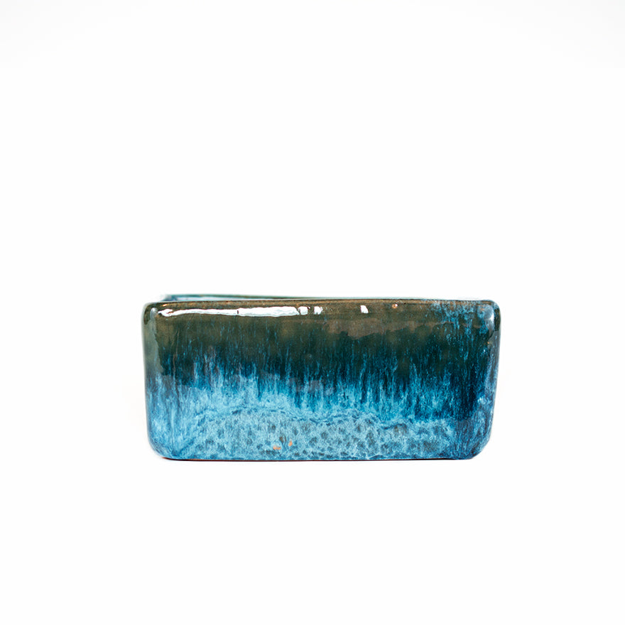 Side photo of small blue glazed square dish planter sold at Bear Valley Nursery